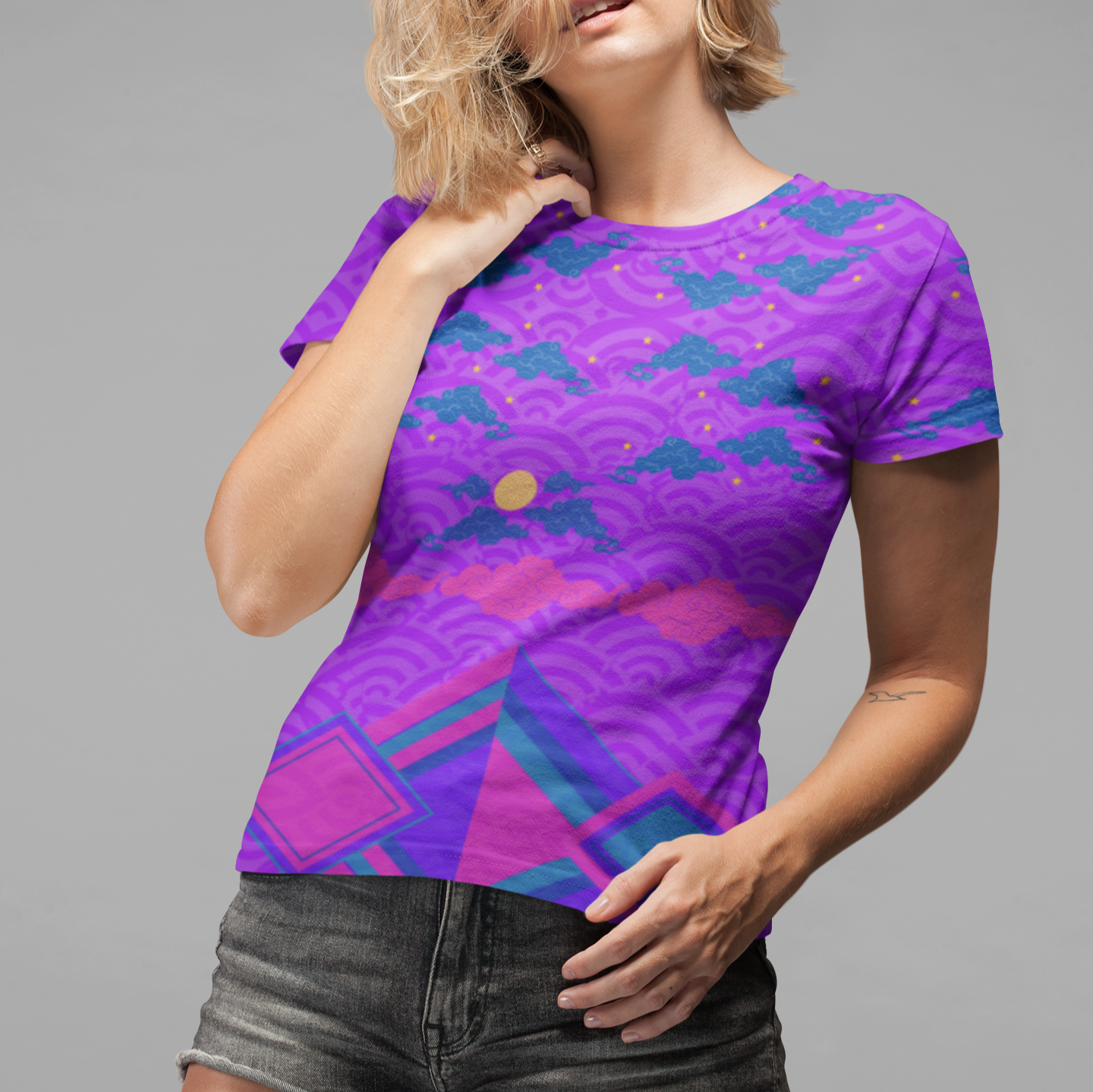 Lady wearing the Chameleon Surf Japan Sky Reflective Mountains Purple Women's T-shirt, showcasing a vibrant blend of rich purples, pinks, and serene turquoise. The T-shirt features a reflective mountain scenery design, capturing the essence of both summer and fall. Crafted from a cotton-touch polyester jersey, this super smooth and comfortable tee is perfect for any season, offering unmatched durability and style.